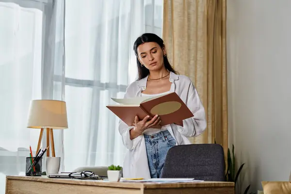 Woman engrossed in reading while in cozy living room. — Stock Photo