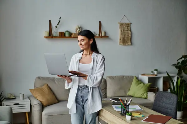 Stylish woman uses laptop in cozy living room. — Stock Photo