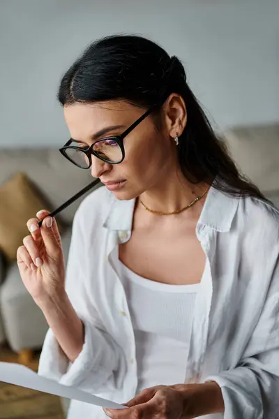 Woman in glasses studying paper. — Stock Photo