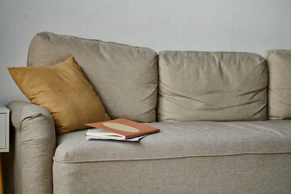 A comfortable couch with a book resting on top of it. — Stock Photo