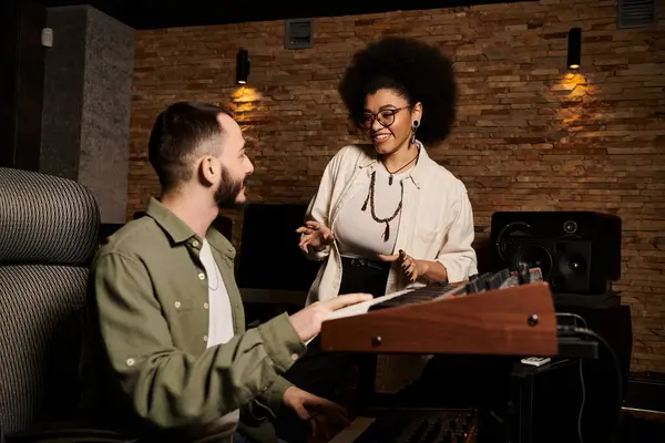 Una donna e un uomo stanno collaborando alla musica in uno studio di registrazione durante una sessione di prove della band. — Foto stock