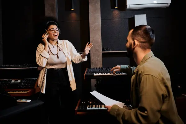 A man and woman from a music band in a recording studio during rehearsal. — Stock Photo