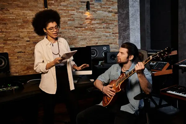 Woman and man collaborate in music band rehearsal within recording studio. — Stock Photo