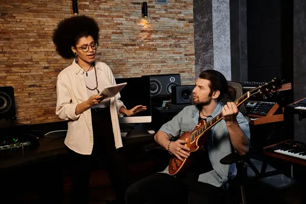 Woman and man collaborate in music band rehearsal within recording studio. — Stock Photo