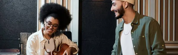 A man and a woman collaborate in a recording studio, working on music for their band rehearsal. — Stock Photo