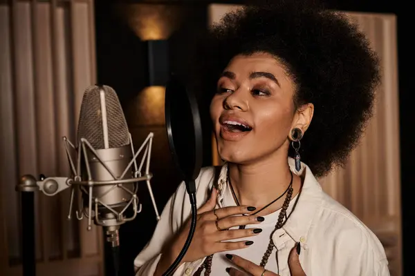 A talented woman pours her heart into singing at a recording studio during a music band rehearsal. — Stock Photo