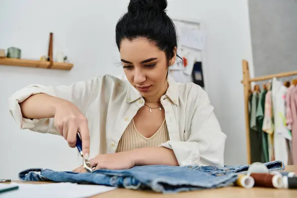 Woman in white shirt cutting jeans for upcycling. — Stock Photo