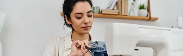 Young woman upcycling clothes with sewing machine for eco-friendly fashion. — Stock Photo