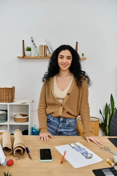 A young woman in casual attire working at a desk, upcycling her clothes for sustainable fashion. — Stock Photo