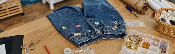 Blue jeans creatively displayed on a rustic wooden table. — Stock Photo