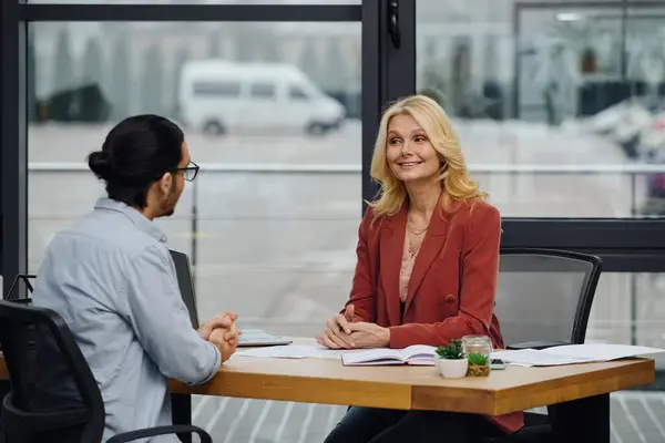 Job seeker interviewing at a modern office desk by woman. — Stock Photo
