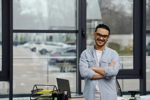 A man stands by a large office window, deep in thought. — Stock Photo
