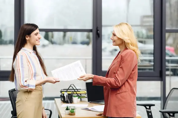 Two women shaking hands in an office during a job interview. — Stock Photo