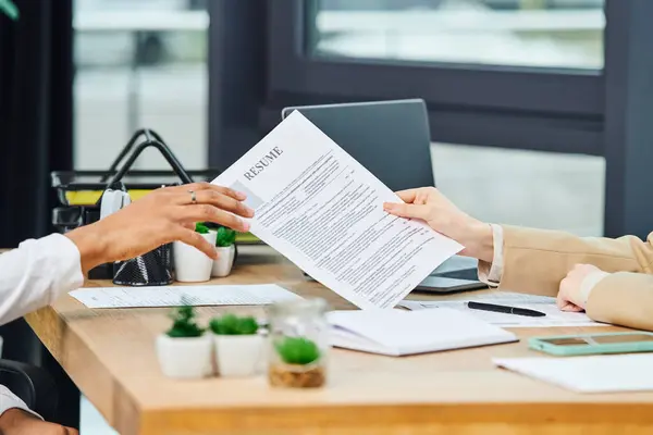 Man handing paper to woman at desk during job interview. — Stock Photo