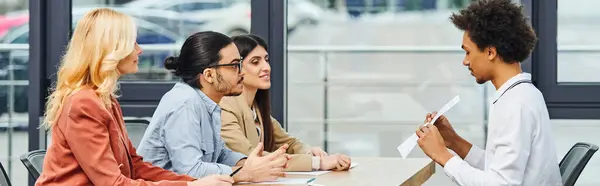 A diverse group of professionals engaging in a productive meeting in a modern office setting. — Stock Photo