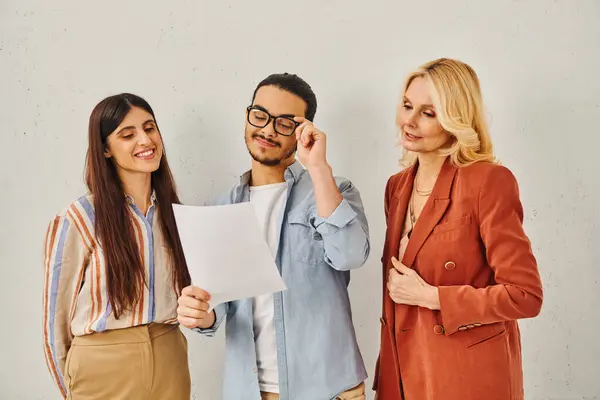 Three business professionals analyzing a document together. — Stock Photo