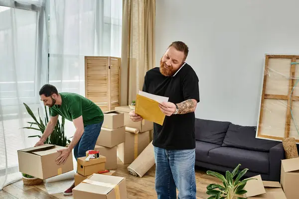 A gay couple stands in their new living room filled with boxes, embarking on a fresh start together. — Stock Photo