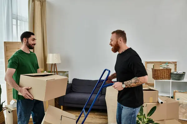 Two men, a gay couple in love, transport and set up boxes in their living room for their new chapter in life. — Stock Photo