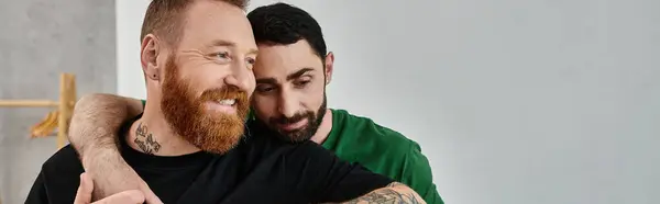 A bearded man warmly embraces his partner — Stock Photo