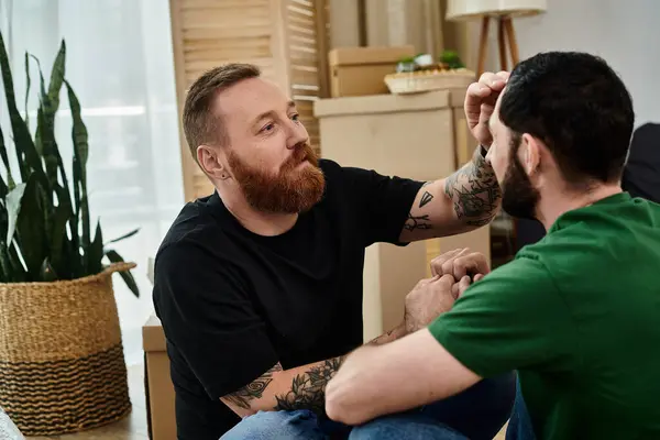 A gay couple holding hands in their new home, embracing their new life together, grooming partner — Stock Photo