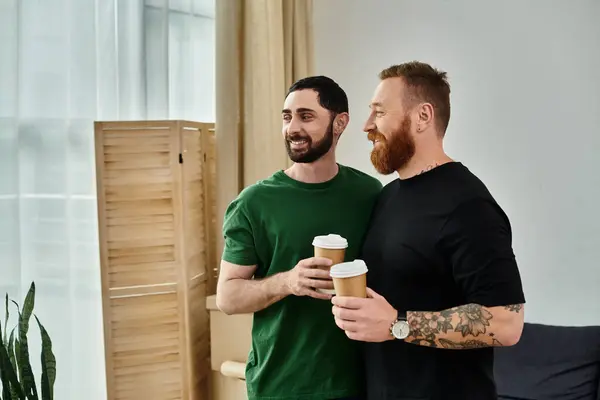 A gay couple in love stands by each others side amidst moving boxes, starting a new chapter in life together. — Stock Photo
