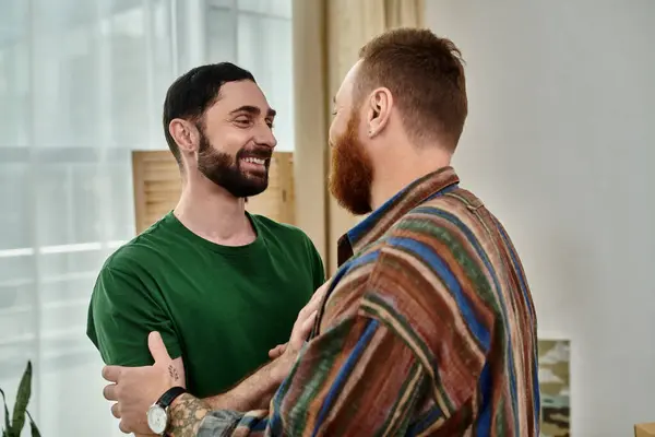 A gay couple excitedly stands in living room, starting anew in their new home. — Stock Photo