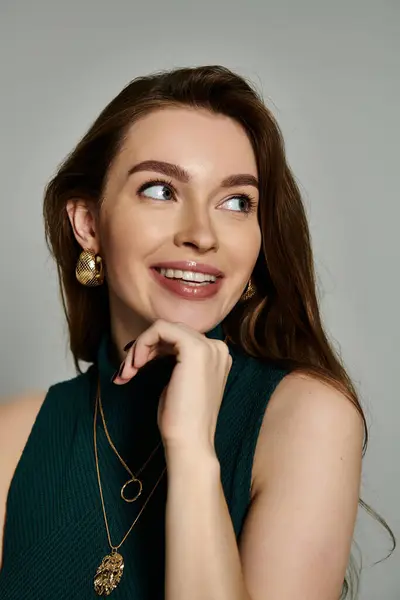 A stylish woman in a vibrant green top elegantly poses for a fashion shoot. — Stock Photo