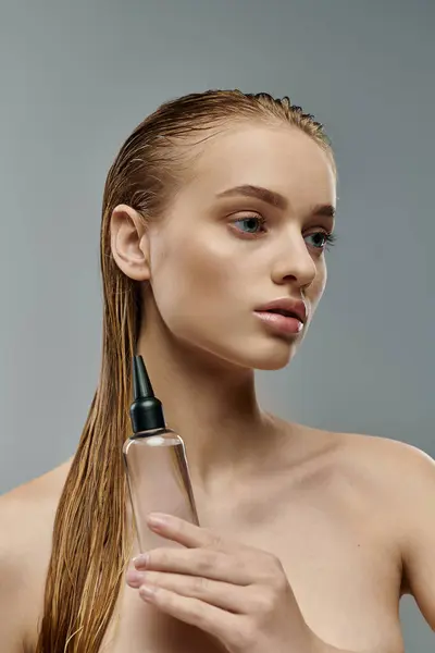 Attractive lady with wet hair using hair care. — Stock Photo