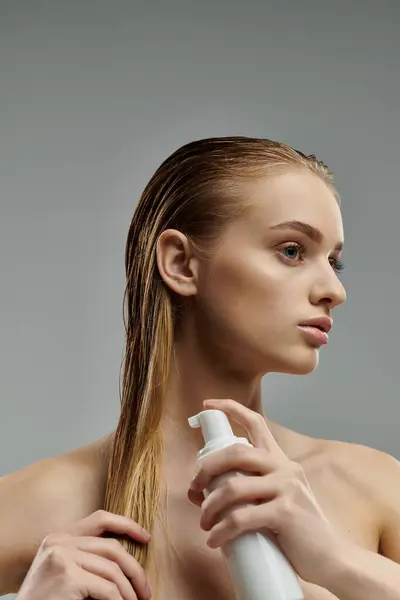 Appealing woman applying hair treatment. — Stock Photo