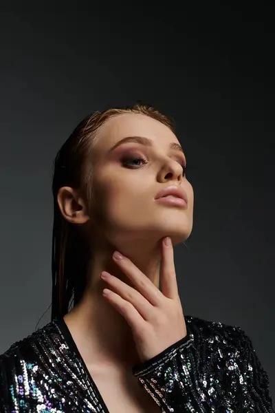 A young, beautiful woman strikes a pose in a shimmering sequin dress. — Stock Photo