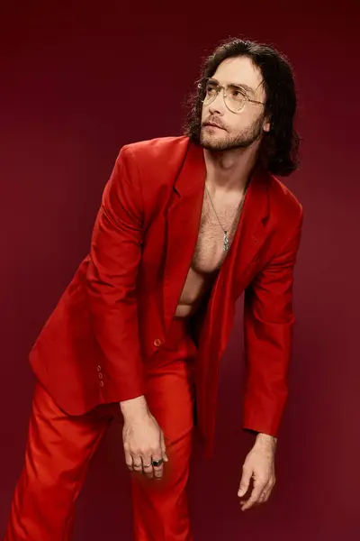 Bonito homem de terno vermelho impressionante pose sem camisa em um estúdio. — Fotografia de Stock