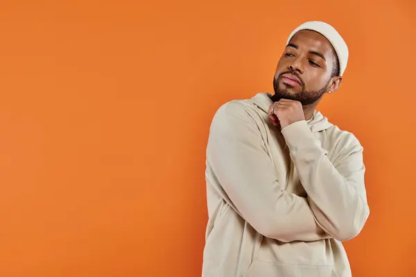 African American man in a white hat standing with hands on chin. — Stock Photo