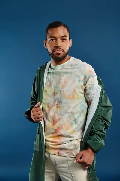 Stylish African American man striking a pose against a vivid blue background. — Stock Photo