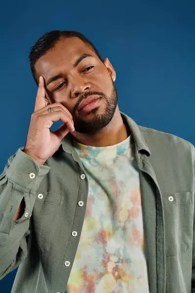 Stylish African American man against vibrant backdrop. — Stock Photo