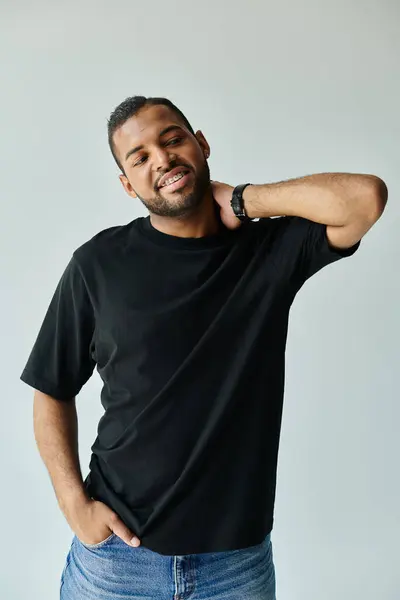 Stylish African American man posing against a vibrant backdrop. — Stock Photo