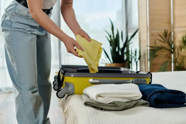 Young woman preparing suitcase at home before her upcoming vacation and trip. — Stock Photo