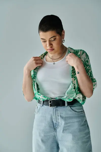 A young woman with short hair exudes a calm and relaxed vibe in her shirt and blue jeans. — Stock Photo