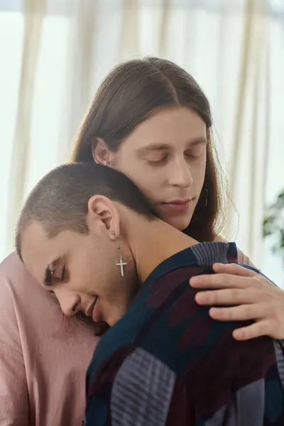Couple in casual clothes tenderly hugs, expressing love and affection in their intimate moment. — Stock Photo