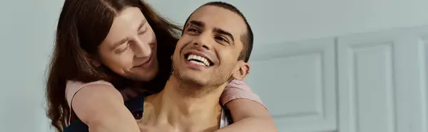 A man tenderly holds a partner in his arms, sharing a moment of intimacy and connection between the loving couple. — Stock Photo
