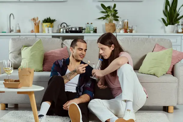 A man and a woman, a gay couple, snuggled up on a cozy couch in casual clothes, enjoying a moment of togetherness. — Stock Photo