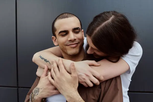 LGBT couple in casual clothes, hugging each other tightly outdoors, showcasing love and togetherness. — Stock Photo
