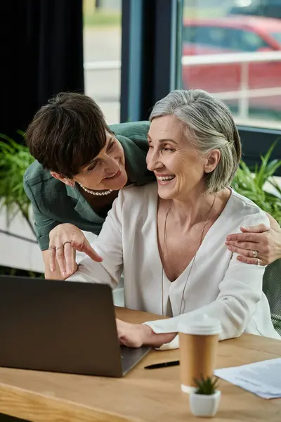 Two women engaged with a laptop. — Stock Photo