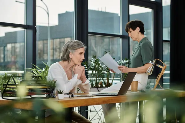 Two women focused, working at table. — Stock Photo