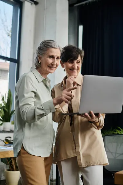 Two women working on laptop together. — Stock Photo