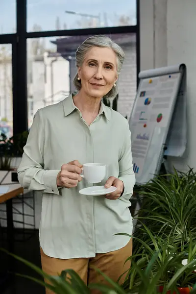 Mature woman enjoying a hot cup of coffee. — Stock Photo