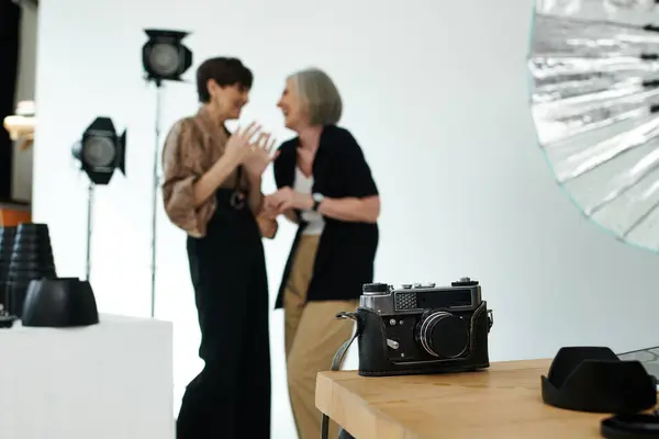 Middle-aged lesbian couple in a studio, focus on camera — Stock Photo