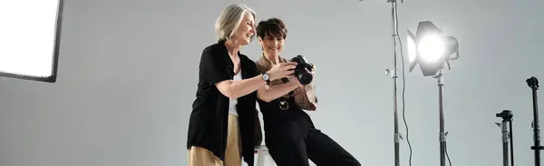A photographer captures her partner modeling in a professional studio setting, showcasing love and creativity. — Stock Photo