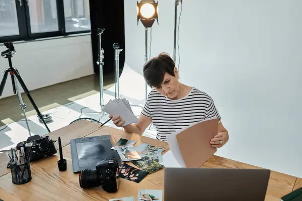 Middle-aged person near laptop on table, professional setting — Stock Photo