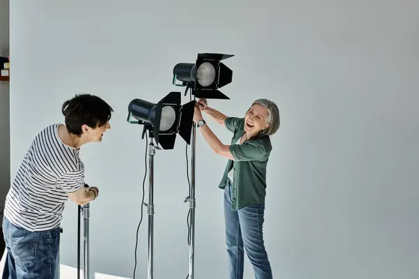 Middle-aged lesbian couple, pose confidently in a modern photo studio. — Stock Photo