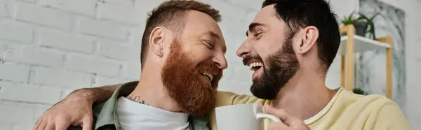 A bearded gay couple stand together, expressing love and togetherness in their living room. — Stock Photo